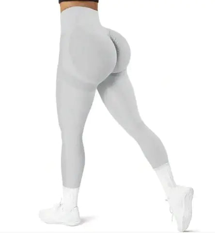 Gray leggings worn by a person on a white background