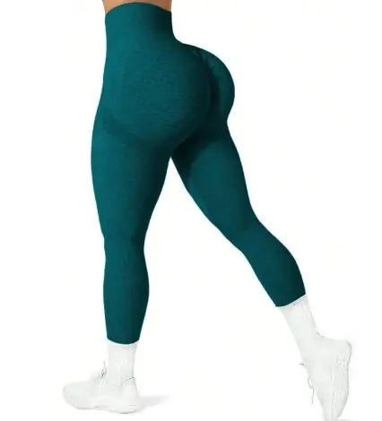 Teal leggings worn by a person on a white background